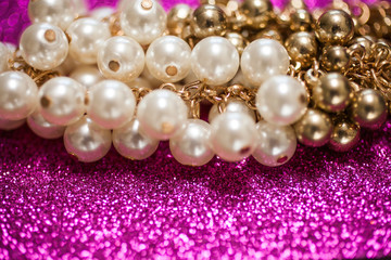 Jewelry background with white and golden pearls