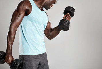 Young man exercising with hand weights