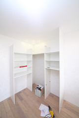 Installation of the white corner cabinet with shelves without doors