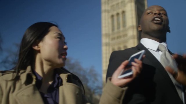  Man in business dress in London being bothered by news reporters