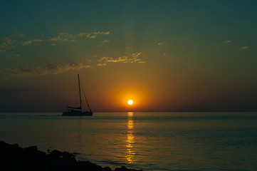 Fototapeta premium Summer sea sunset with sailboat