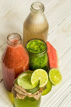 green and red smoothies in a jar with lime, kiwi