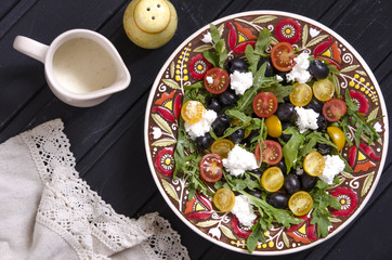 Arugula salad with cherry tomatoes feta and olives  