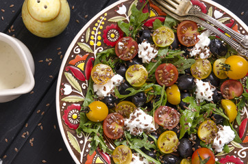 Arugula salad with cherry tomatoes feta and olives  