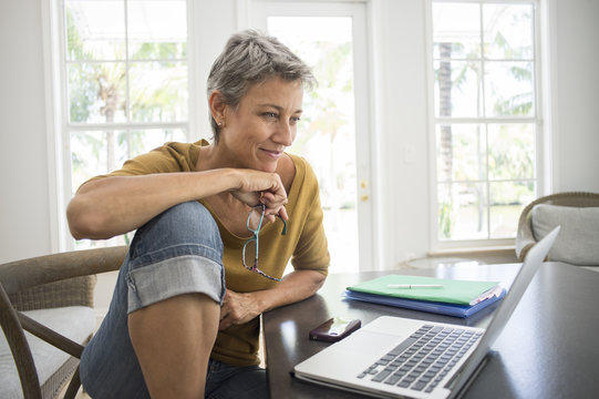 Woman using laptop in living room