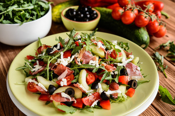 Arugula salad with baked Black Forest ham, cucumber, black olives, red pepper, tomato and Mozzarella