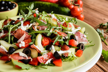 Arugula salad with baked Black Forest ham, cucumber, black olives, red pepper, tomato and Mozzarella