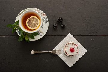 tea with lemon and mint and cherry cake