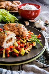 Baked chicken breast stuffed with Feta cheese, sun dried tomato and basil with steamed pepper, zucchini, tomato and stalk celery and rice