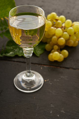 yellow grapes and wine in the glass