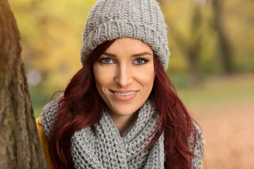 Smiling girl with a gray scarf and cap