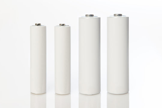 white aa and aaa batteries on white background