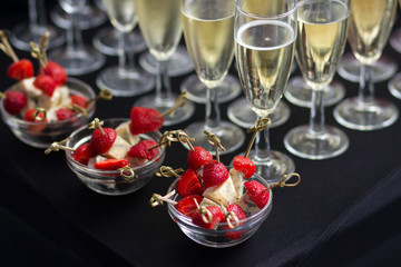 Fototapeta na wymiar Canapes of cheese and strawberries with champagne
