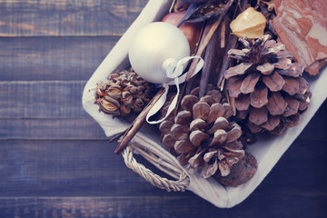 New Year's toy, cones cedar and natural scenery by new year in a basket on a wooden surface