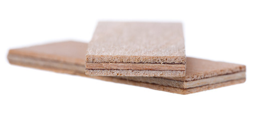 Close up heap of wooden dowel pins isolated on white