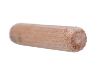 Close up heap of wooden dowel pins isolated on white