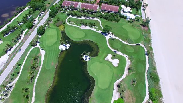 Aerial - Beautiful view of Golf Course next to ocean - looking down to the lake