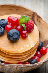 Stack of pancakes with blueberry and fresh berry.