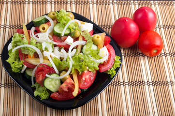Useful and natural vegetable salad of tomato, cucumber, olives