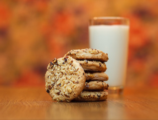 Stack of a homemade oatmeal cookies, shot on a wooden table. Shot with a shallow depth of field and a warm color tone.