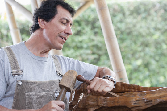 Colombian sculptor working on wood