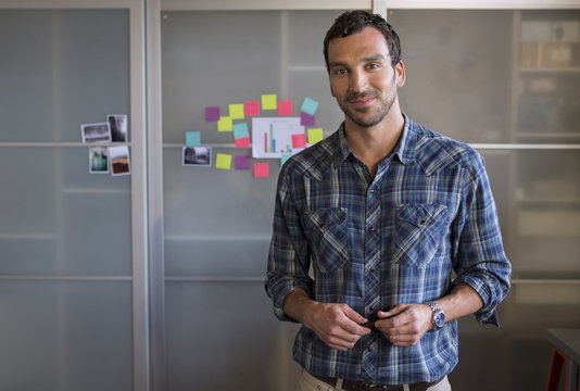 Caucasian businessman smiling in office