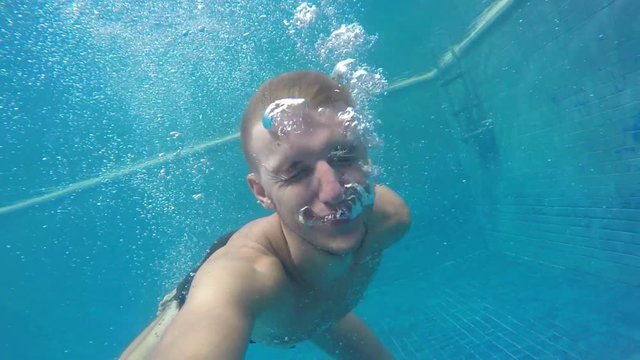 Man Swimming Under Water in Pool with GoPro. Slow Motion.