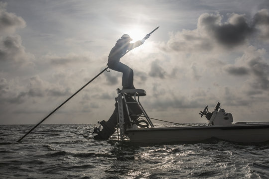 Caucasian fisherman rowing boat on ocean