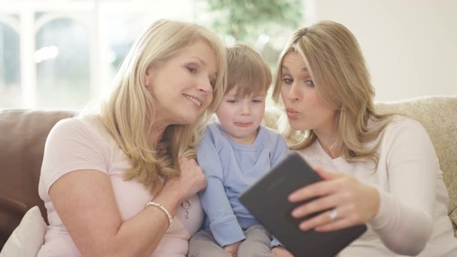  3 Generations of happy family taking selfie with tablet computer
