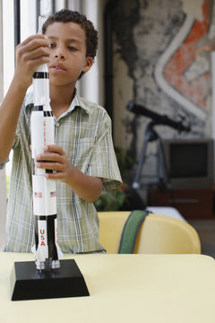 Boy building model rocket