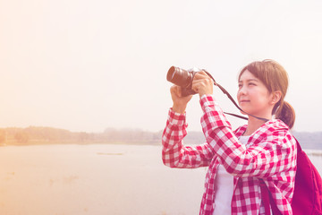 young woman girl is travel with backpack and handle camera of ta