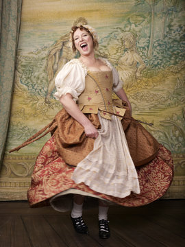 Actress dressed in old-fashioned costume on stage