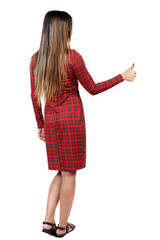 Back view of  woman thumbs up. Rear view people collection. backside view of person. Isolated over white background. The girl in red plaid dress shows thumb up.
