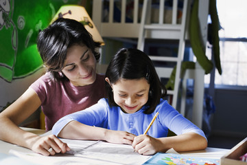 Mother helping daughter with homework