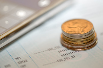 Coins, calculator, and saving account passbook