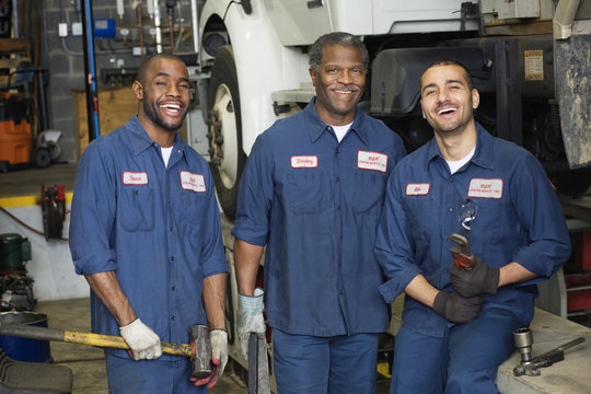 Mechanics standing in repair shop