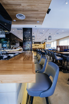 Empty tables and chairs in modern bar and restaurant
