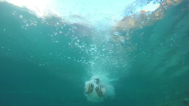 Man Diving Underwater in Swimming Pool. Slow Motion.