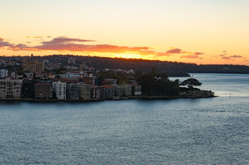 Sun rising over Kirribilli suburb and Sydney Harbour. Urban morning landscape scene. Sydney, NSW, Australia