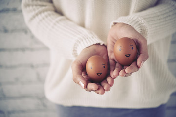 Woman showing eggs with smiles on them