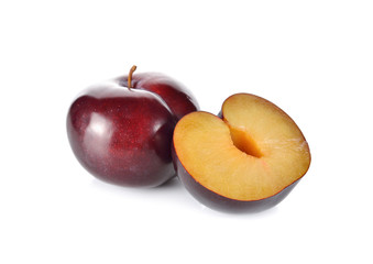whole and half cut ripe plum on white background
