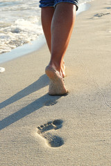 footprints in the sand on the beach