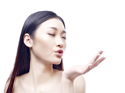 Beautiful Young Asian Woman Blowing A Kiss