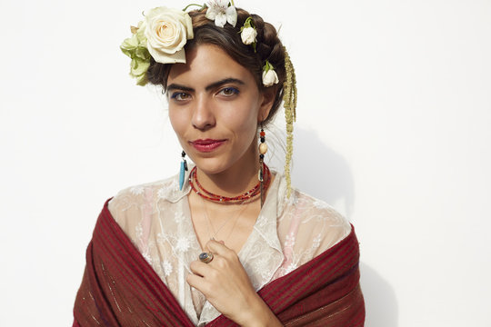 Stylish woman wearing shawl and flowers in hair