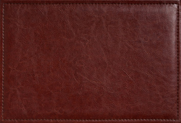 Brown leather texture closeup may be used for any background. Blank natural leather label jeans tag isolated. Rustic macro background.