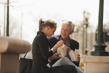 Caucasian business people eating Asian food