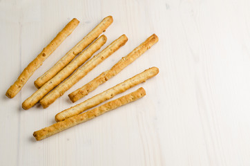 rustic breadsticks on wood table, close up, background.