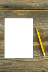 Pencil and white card on the wooden desk/Pencil and white card on the wooden desk