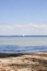 Fototapeta na wymiar sailing boat in the middle of a lake near the coast in France