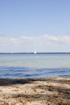 sailing boat in the middle of a lake near the coast in France